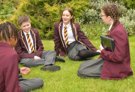 windsor olympus academy students sat in the garden chatting