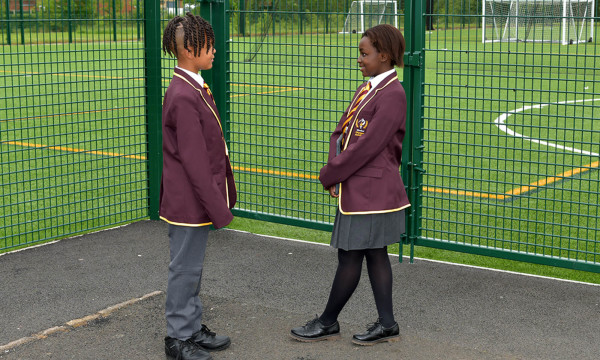 two windsor olympus academy students talking by the artificial sports pitch